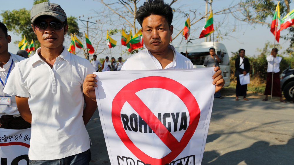 People protest as an aid ship carrying emergency supplies for Rohingya Muslims arrives at the port in Yangon [Soe Zeya Tun/Reuters]
