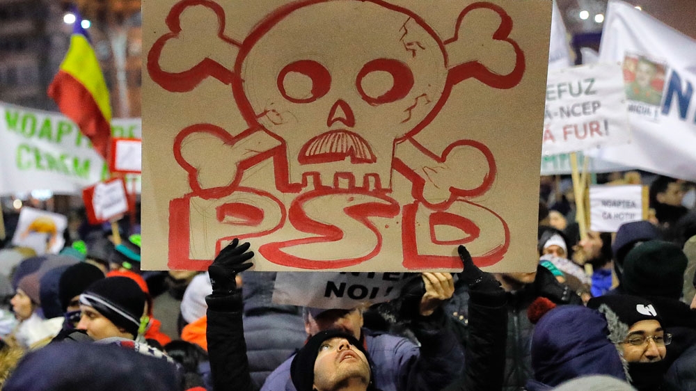 Romanians are protesting against a controversial law giving pardon to corruption crimes [AP]