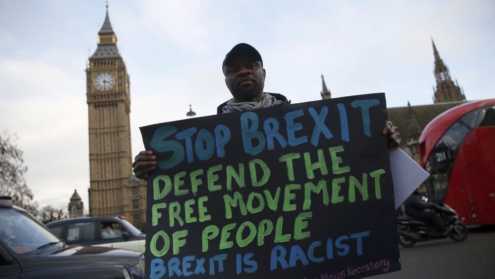 An anti-Brexit protester holds a sign outside the Houses of Parliament in London