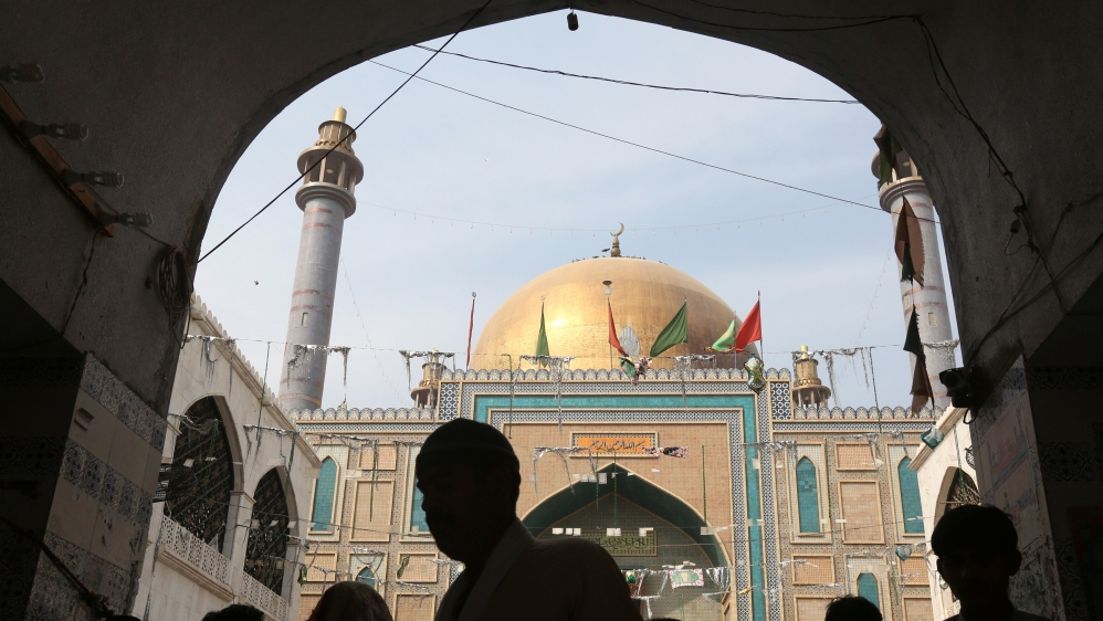 Devotees are silhouetted as they gather at the tomb of Sufi saint Syed Usman Marwandi, also known as the Lal Shahbaz Qalandar shrine, after Thursday''s suicide blast, in Sehwan Sharif