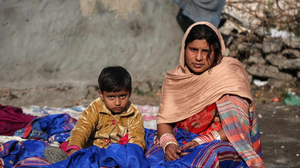 Hemlata, 29, has had to borrow money from moneylenders to pay for medication for her chronically ill daughter. But, she asks, 'How am I going to repay that money?' [Showkat Shafi/Al Jazeera]