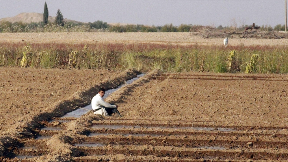 A farmer rests in the countryside of Raqqa, eastern Syria [Nour Fourat/Reuters]