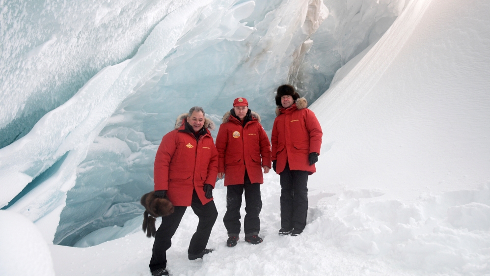 Russian President Putin, PM Medvedev and Defence Minister Shoigu pose for a picture during visit to cave of Arctic Pilots Glacier in Alexandra Land in remote Arctic islands of Franz Josef Land