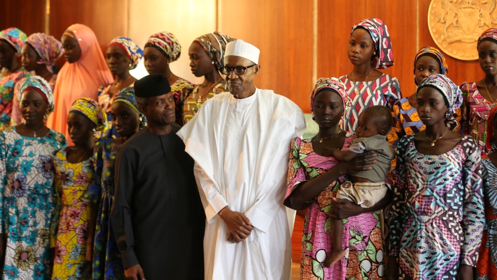 Some of the 21 Chibok schoolgirls released by Boko Haram pose during a group photograph with President Muhammadu Buhari and Vice President Yemi Osinbajo In Abuja, Nigeria