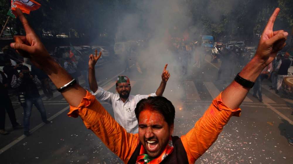 Supporters of India’s Bharatiya Janata Party (BJP) celebrate after learning of the initial poll results outside the party headquarters in New Delhi, India