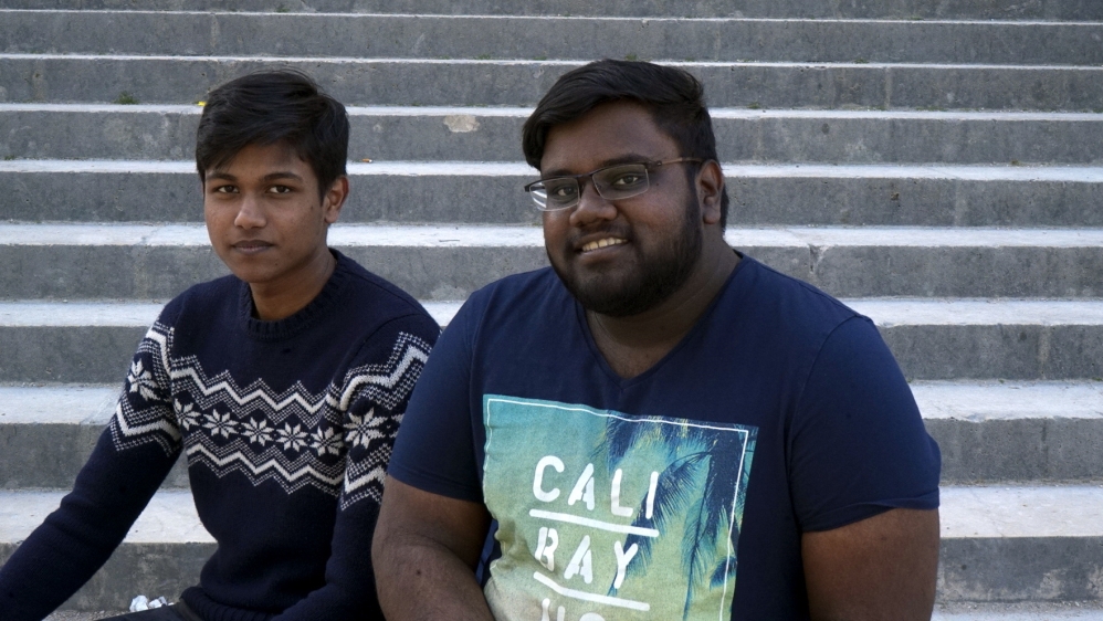 Steban (left) and Jagan support Jean-Luc Melenchon [Shafik Mandhai/Al Jazeera]