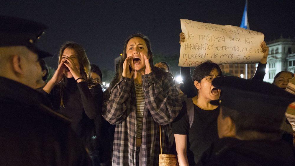 On March 13, in Guatemala City, women chant slogans against Guatemala's President Jimmy Morales, as he attends mass at the Metropolitan Cathedral, to demand justice for the girls who perished in a fire at the children's shelter [AP/Moises Castillo]
