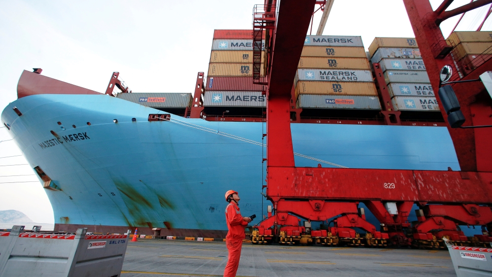 A worker is seen next to the Maersk''s Triple-E giant container ship Maersk Majestic at the Yangshan Deep Water Port in Shanghai
