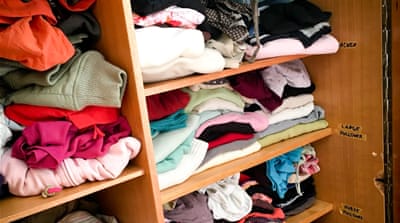 Donated clothes are organised inside the Clausnitz school [Jacob Kushner/Al Jazeera]