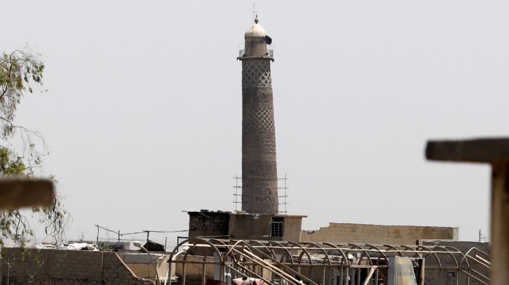 An ISIL flag was seen on top of the minaret of the al-Nuri mosque in the Old City in western Mosul before it was destroyed [Erik De Castro/Reuters]