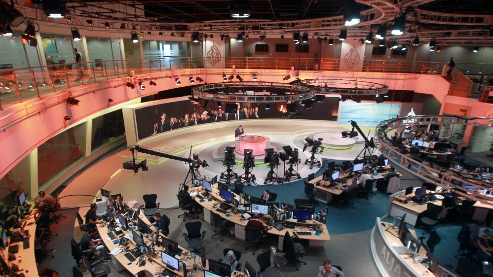 Staff work inside the Al Jazeera Network HQ in Doha