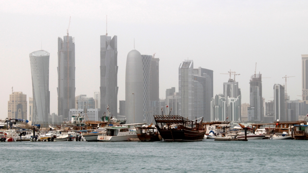 FILE PHOTO: Traditional fishing Dhows are seen in port near modern glass and steel buildings on the Doha skyline