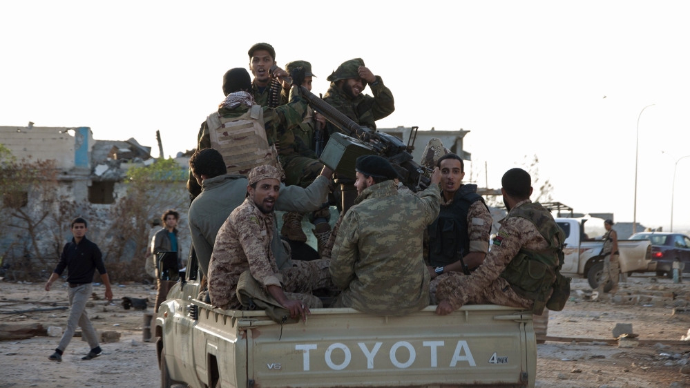 Members of forces loyal to former general Khalifa Haftar ride in a truck in the Benina area, east of Benghazi