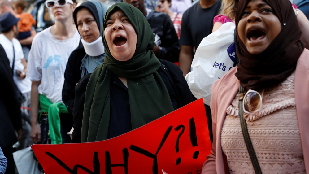 Demonstrators shout outside Kensington Town Hall, during a protest following the fire that destroyed The Grenfell Tower block, in north Kensington, West London