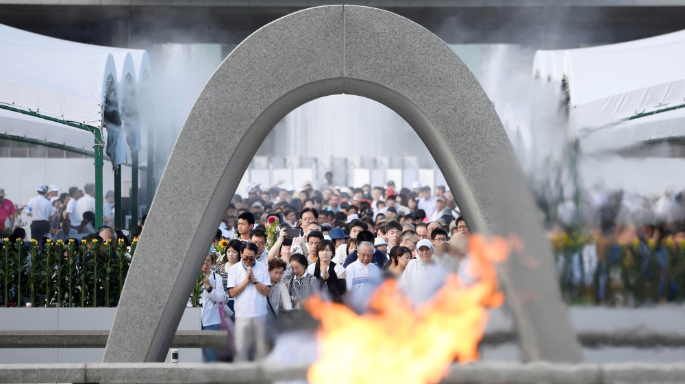 People pray for atomic bomb victims in front of the cenotaph for the victims of the 1945 atomic bombing in Hiroshima