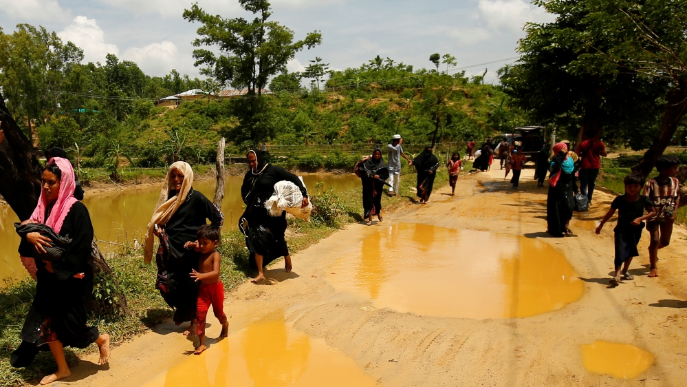 Rohingya Muslims enter Bangladesh from a makeshift shelter near Cox's Bazar [Mohammad Ponir Hossain/Reuters]