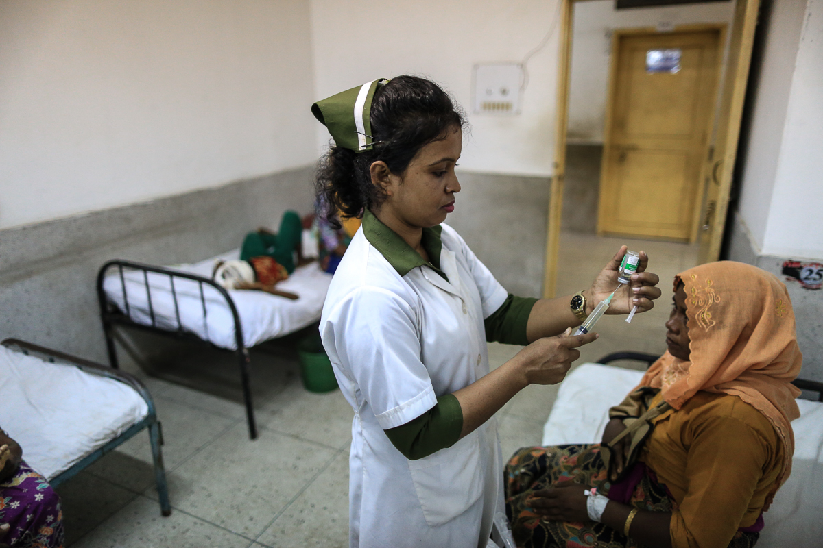 Nurse Shakeeba, 25 attends to a patient. She has been working in the hospital for the past 9 months and was transferred to this ward ( the wards treating Rohingya refugees), 4 days back. She says, " T
