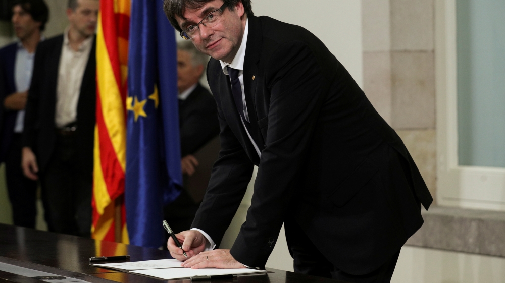 Catalan President Carles Puigdemont signs a declaration of independence Catalan regional parliament in Barcelona