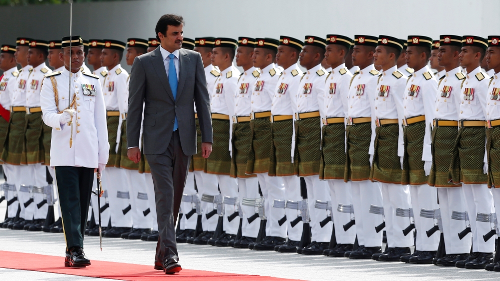 Qatar''s Emir Sheikh Tamim bin Hamad al-Thani inspects an honour guard during a state welcome ceremony at the Parliament House in Kuala Lumpur