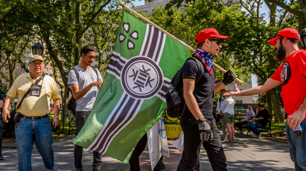 In New York City, an alt-right protester carries the Kekistan flag [Pacific Press/Getty Images]