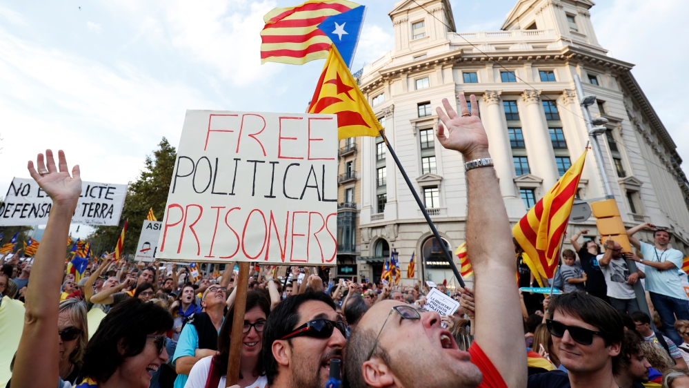People wave placards and Catalan flags during a protest organised by Catalan pro-independence movements Catalan National Assembly (ANC) and Omnium Cultural, following the imprisonment of their two leaders [Rafael Marchante/Reuters] 