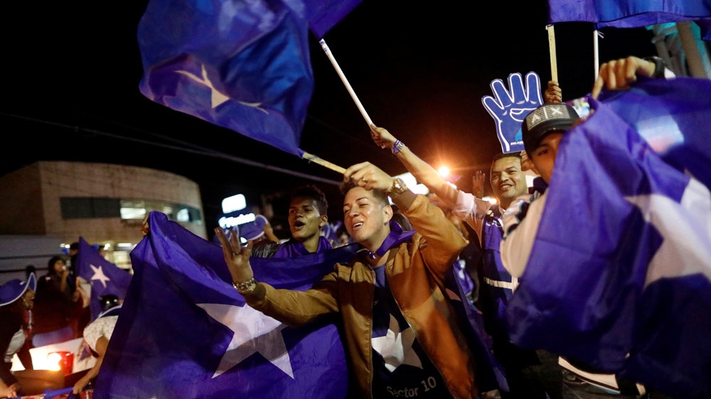 Supporters of President Juan Orlando Hernandez celebrate as they wait for official presidential election results [Edgard Garrido/Reuters]