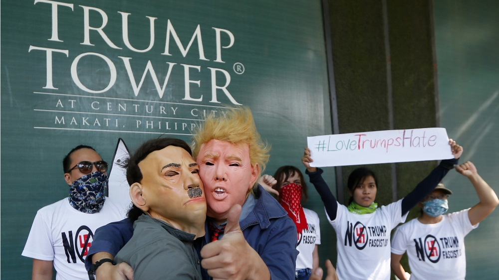 Protesters hold a brief picket at the Trump Tower hours after Trump was sworn in as the 45th President of the United States on January 21, 2017 in Manila, Philippines [AP/Bullit Marquez]