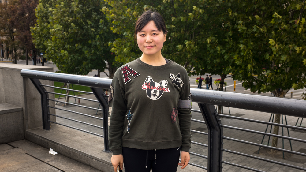 Zhang Xing, 24, is no fan of President Trump [Denise Hruby/Al Jazeera]