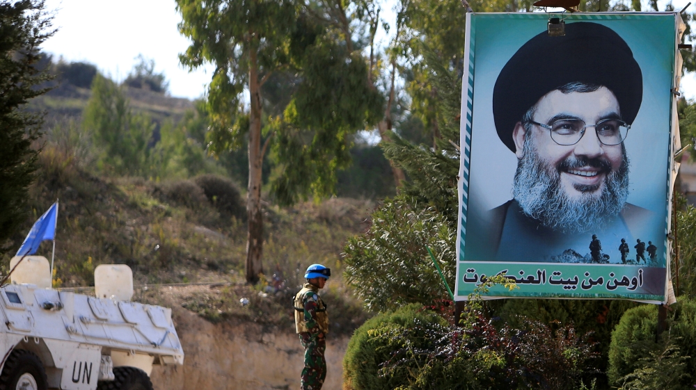 A U.N peacekeepers of the United Nations Interim Force in Lebanon (UNIFIL) stands near a poster depicting Lebanon''s Hezbollah leader Sayyed Hassan Nasrallah in Adaisseh in southern Lebanon