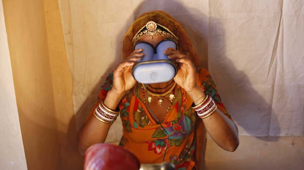 A villager goes through the process of eye scanning for UID database system at an enrolment centre at Merta district in Rajasthan