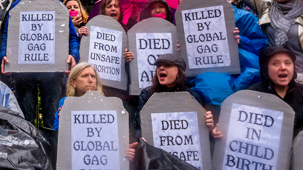 A coalition of physicians, AIDS activists, medical students, and women's health and rights advocates protest against Trump's
