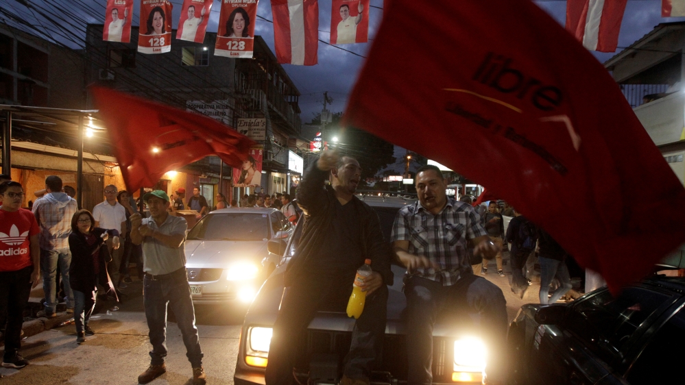 Opposition supporters wave flags during a protest over the contested presidential election [Jorge Cabrera/Reuters] 