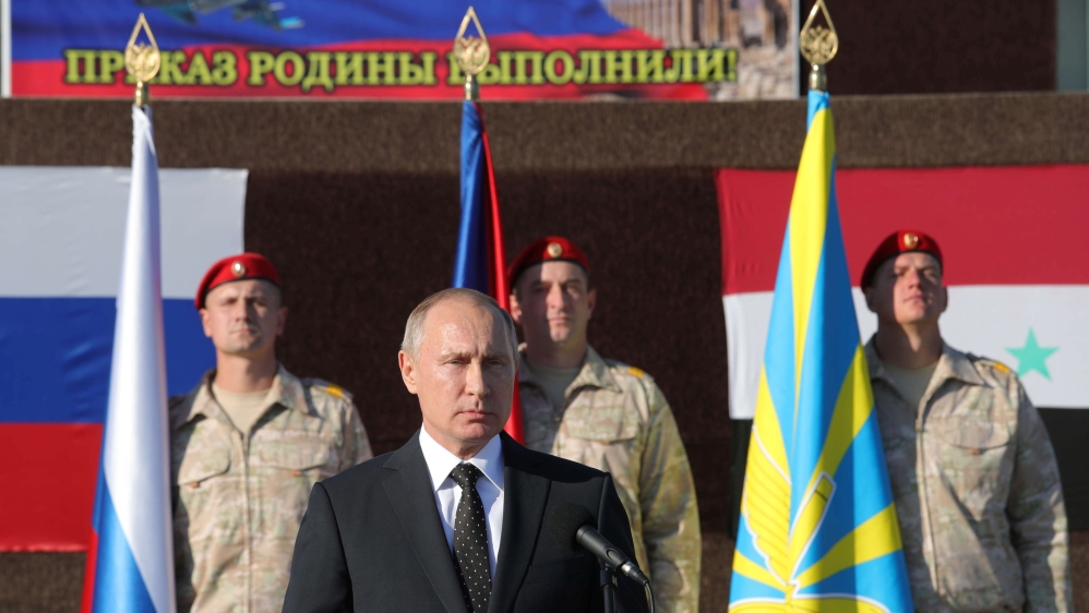 Russian President Putin addresses servicemen as he visits the Hmeymim air base in Latakia Province