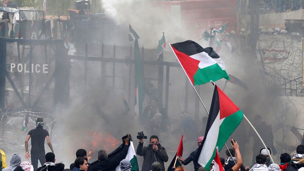 Security forces responded by firing tear gas canisters and using water cannon to disperse the protesters [Mohamed Azakir/Reuters]