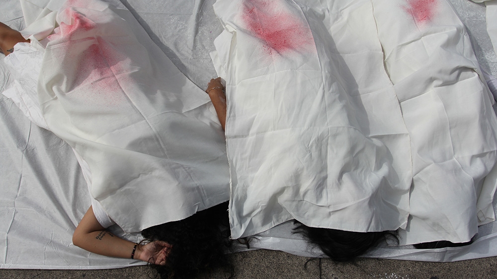 Women protest the strict abortion laws in San Salvador [Ali Rae/Al Jazeera]