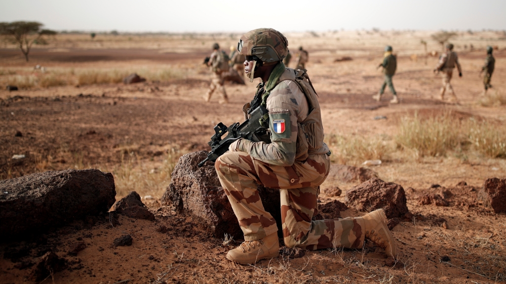 Troops from the Malian Armed Forces and French soldiers conduct a joint patrol during the regional Operation Barkhane in Inaloglog, Mali