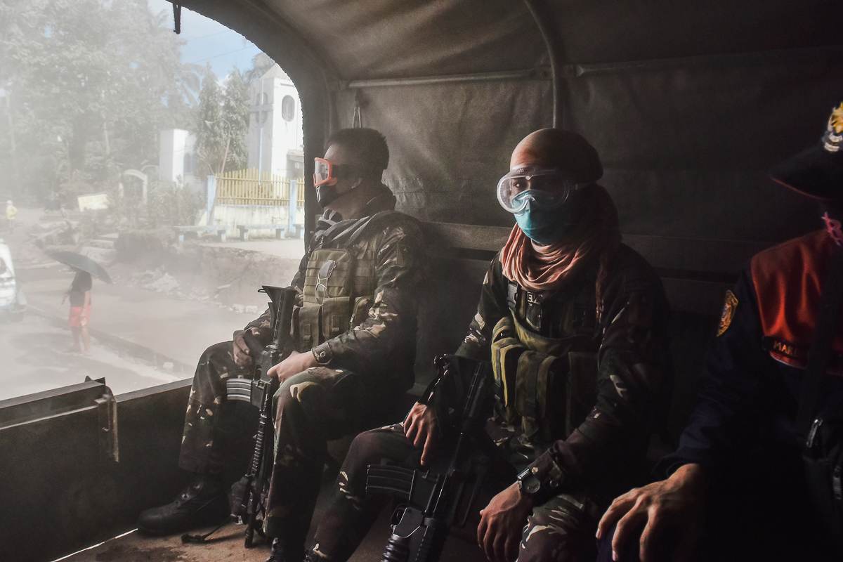Soldiers ride a military truck on their way to rescue residents inside the extended danger zone around Mount Mayon in Guinobatan, Albay province, Philippines, January 23, 2018. Police and military per