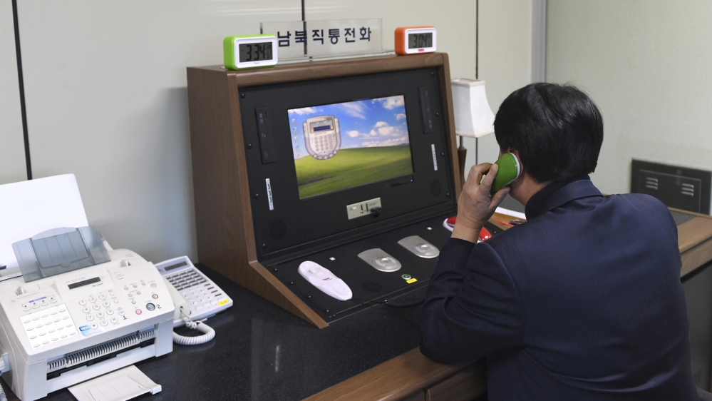 A South Korean government official communicates with a North Korean officer during a phone call on the dedicated communications hotline at the border village of Panmunjom in Paju, South Korea