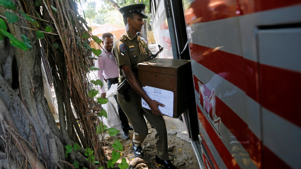 An electoral officials carries a ballot box as he gets into a bus ahead of local government polls in Colombo, Sri Lanka February 9, 2018. REUTERS/Dinuka Liyanawatte