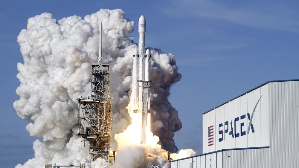 A Falcon 9 SpaceX heavy rocket lifts off from pad 39A at the Kennedy Space Center in Cape Canaveral. The Falcon Heavy, has three first-stage boosters, strapped together with 27 engines in all. [John Raoux/AP]