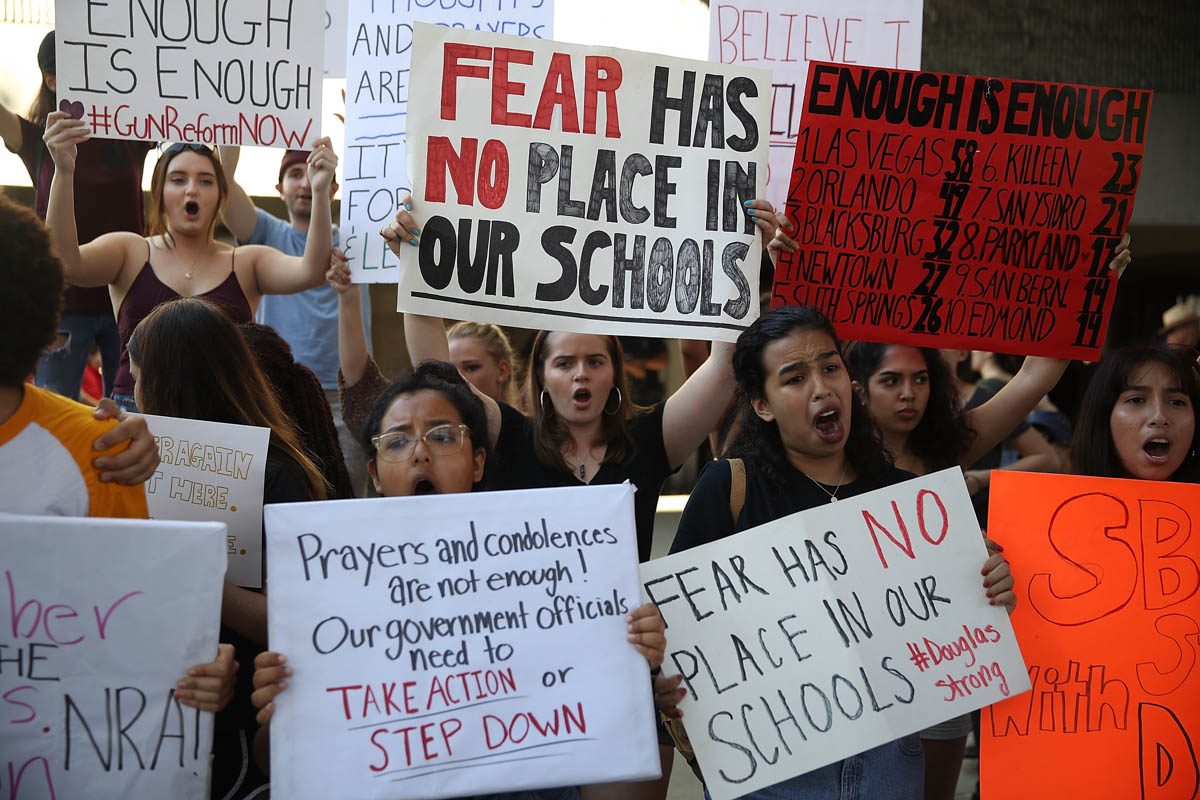 People join together after a school shooting that killed 17 to protest against guns on the steps of the Broward County Federal court on February 17, 2018 in Fort Lauderdale, Florida