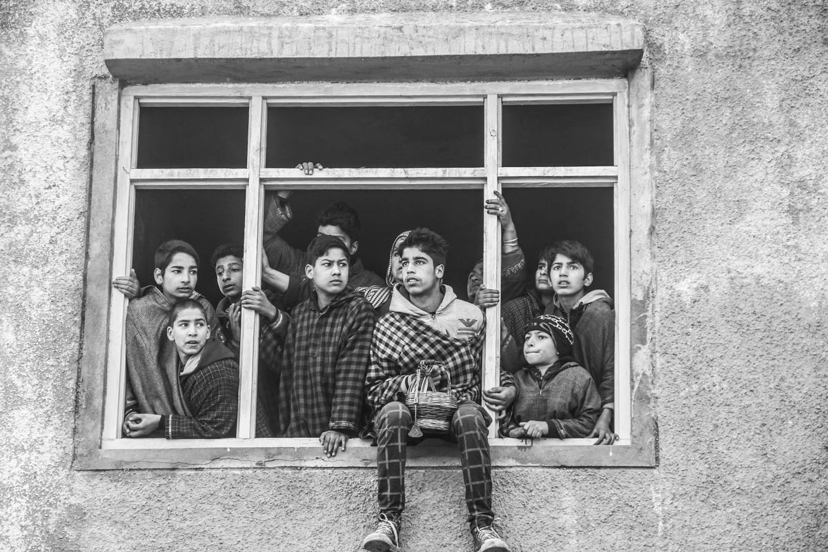 Children watching funeral procession of a slain militant from a house at village Hablish in Kulgam district, about 72 km south of Srinagar city, the summer capital of Indian-controlled Kashmir.