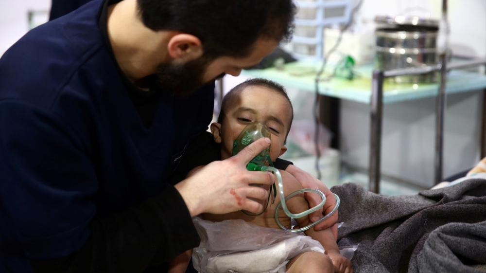 Man with a child are seen in hospital in the besieged town of Douma, Eastern Ghouta, Damascus, Syria February 25, 2018. Picture taken February 25, 2018. REUTERS/Bassam Khabieh