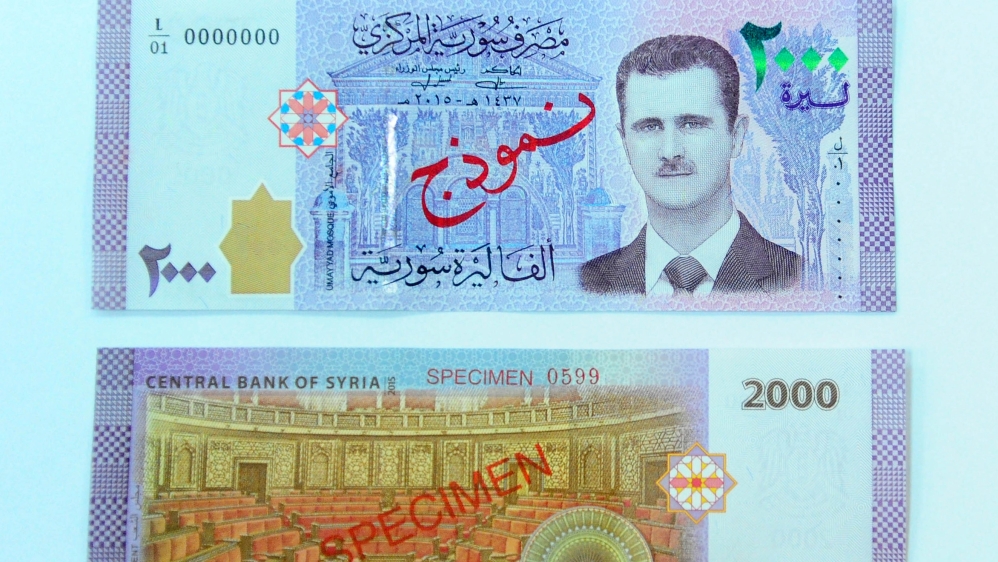 A portrait of Syria's President Bashar al-Assad is seen printed on the new Syrian 2,000-pound banknote that went into circulation in July 2017 [Reuters]