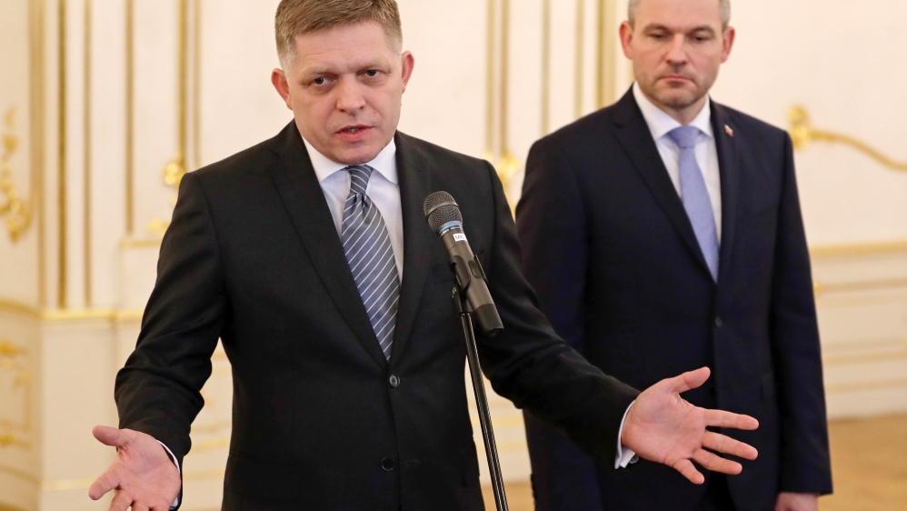 Outgoing Slovak Prime Minister Robert Fico speaks after tendering his resignation to the president as his successor Peter Pellegrini looks on in Bratislava