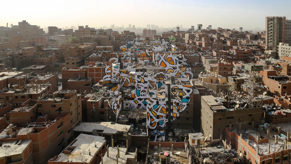 This mural is painted across around 50 buildings in Cairo [Courtesy: eL Seed studio]