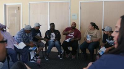 Chavez runs a relapse prevention meeting at Homeboy Industries, an organisation that helps former gang members become productive members of society [Al Jazeera]