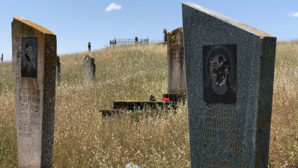 Graves defaced by bullet holes in Ashagi Abdurahmanli, a few hundred metres from Armenian military positions [Shafik Mandhai/Al Jazeera]