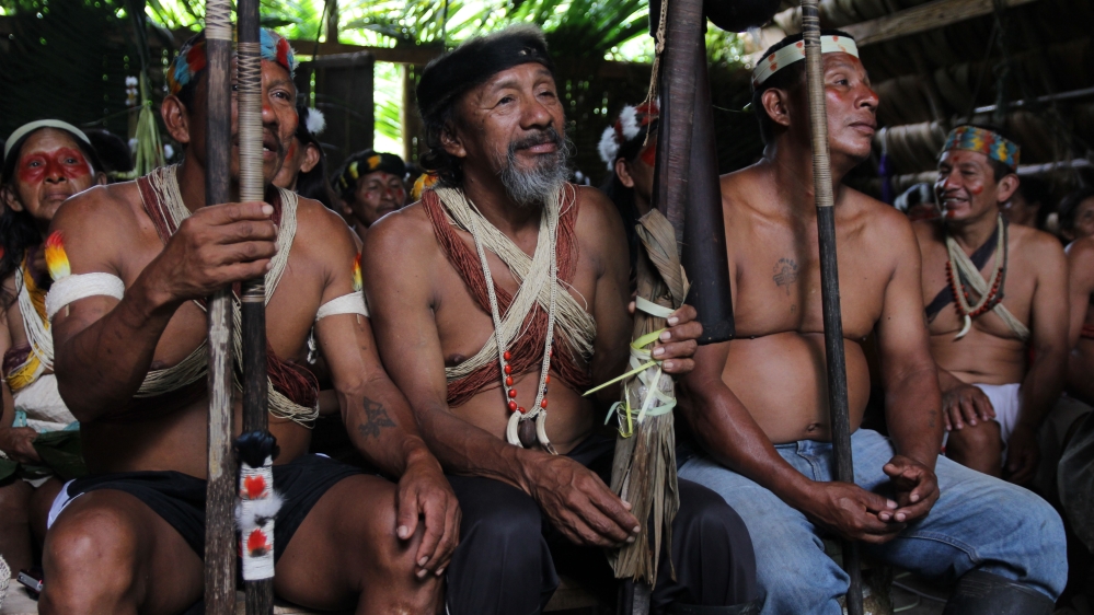 Waorani men gathered to finalise details about their international petition against oil block 22. [Kimberley Brown/Al Jazeera]