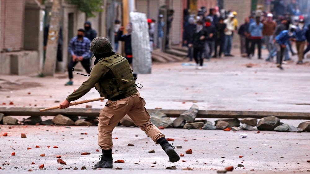 Demonstrators throw stones towards the Indian police during a protest against the recent killings in Kashmir, in Srinagar May 8, 2018. [Danish Ismail/Reuters]